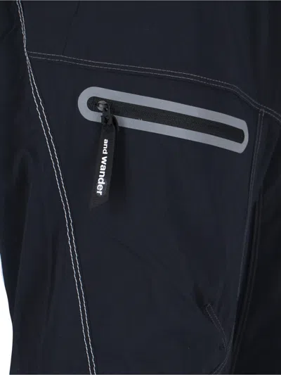And Wander Streamlined Black Trousers With Zippered Pockets In Blue