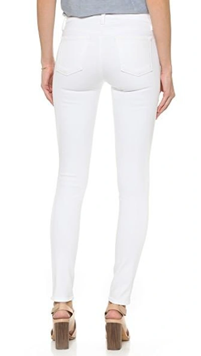 Shop J Brand 811 Mid Rise Skinny Jeans In Blanc