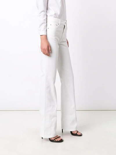 Shop Saint Laurent Flared Leg Jeans In White