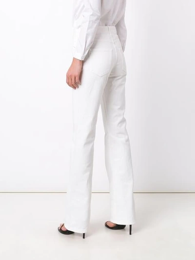 Shop Saint Laurent Flared Leg Jeans In White