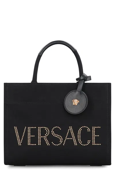 Versace Studded Logo Canvas Tote Bag In Black