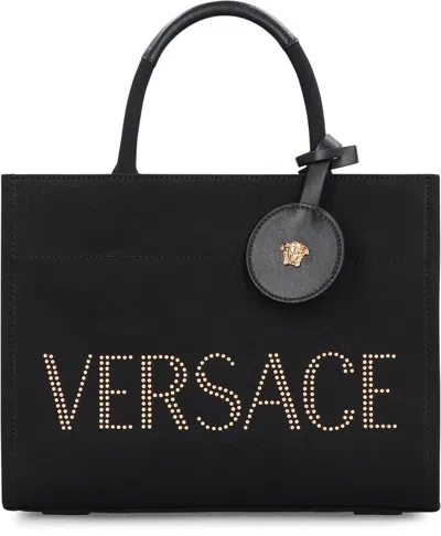 Versace Studded Logo Canvas Tote Bag In Black