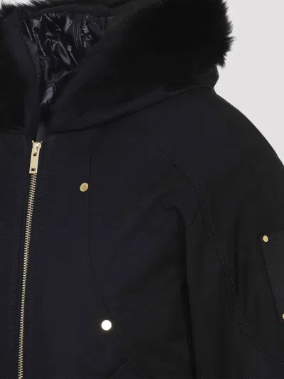 Moose Knuckles Fitted Hooded Jacket With Plush Fur Trim And Metallic Accents In Black