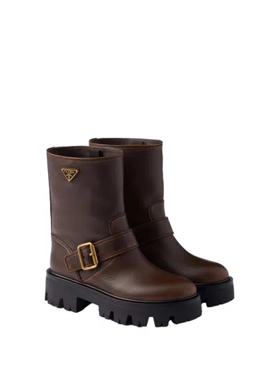 Prada Triangle Logo Distressed Leather Ankle Boots In Brown