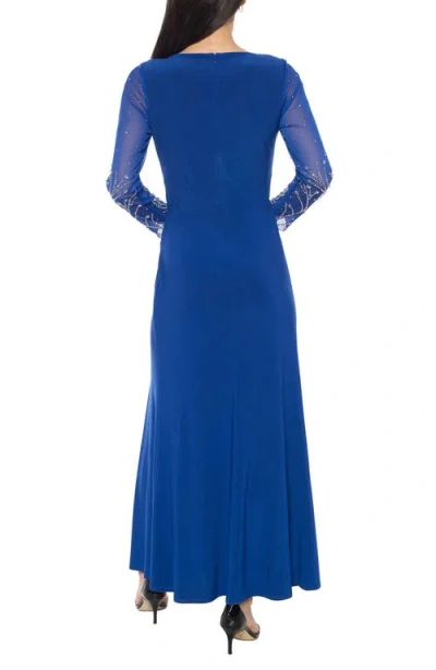 Marina Crystal Embellished Long Sleeve Faux Wrap Gown In Blue