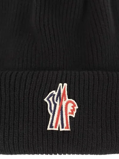 Moncler Logo-embroidered Ribbed Wool Beanie In Black