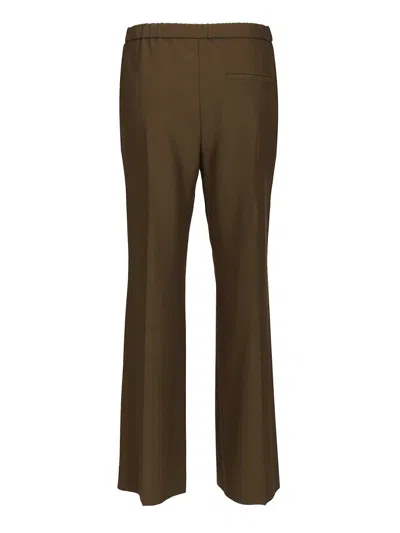 Loewe Logo Embossed Pleat Detail Trousers In Brown