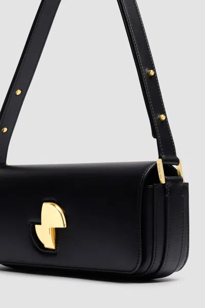 Patou Shoulder Bag With Structured Silhouette And Adjustable Strap In Black