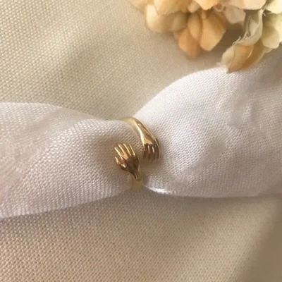 Spero London Hug Ring With Hands Sterling Silver And Gold Plated In Gold