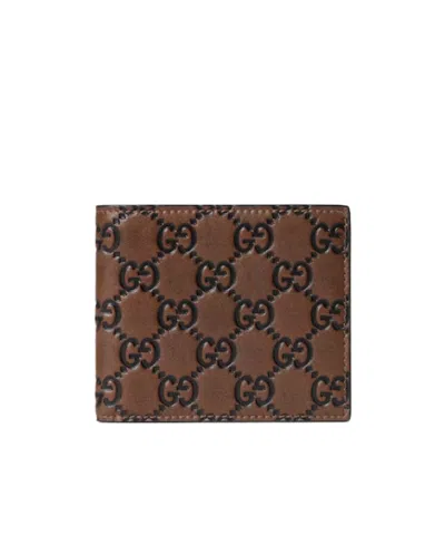 Gucci Men Gg Emblem Leather Wallet With Embossed Gg Logo In Brown