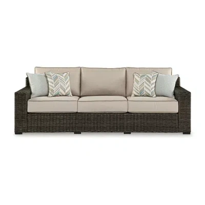 Signature Design By Ashley Coastline Bay Outdoor Sofa With Cushions In Brown