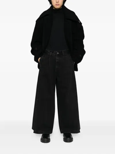 Songzio Asymmetric Cut Flare Jeans In Black