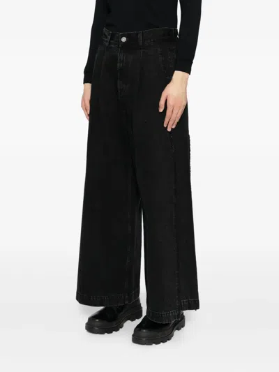 Songzio Asymmetric Cut Flare Jeans In Black