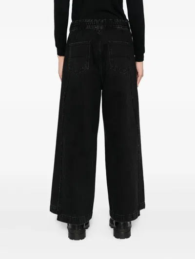 Songzio Asymmetric Cut Flare Jeans In Black