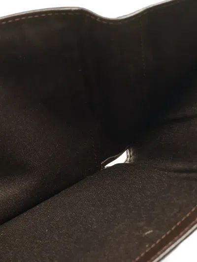 Pre-owned Carolina Herrera Vintage Monogram-embossed Leather Wallet In Brown