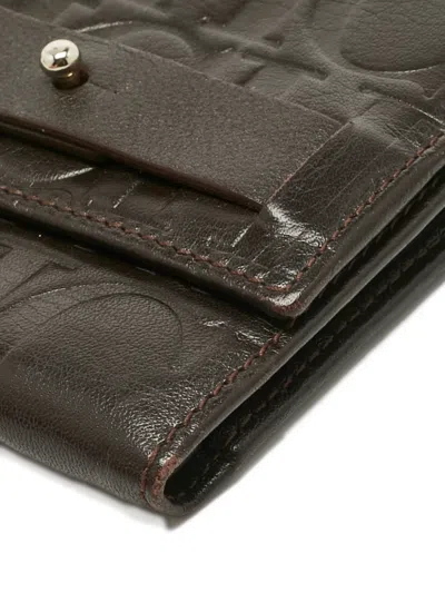 Pre-owned Carolina Herrera Vintage Monogram-embossed Leather Wallet In Brown
