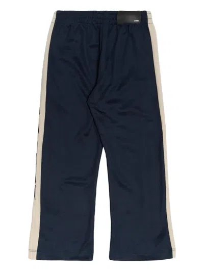 Amiri Stripe Logo Track Pants In Blue