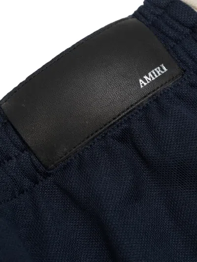 Amiri Stripe Logo Track Pants In Blue