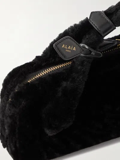 Alaïa Le Teckel Leather-trimmed Shearling Clutch In Black