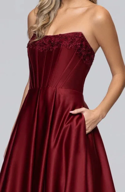 Blondie Nites Lam Corset Strapless Satin Gown In Burgundy