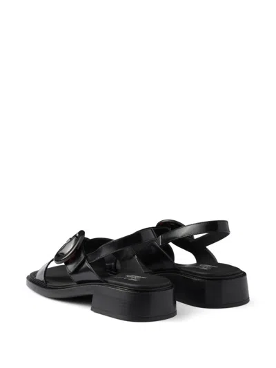 Prada Brushed Leather Crisscross Band Sandals With Plexiglas Buckle In Black
