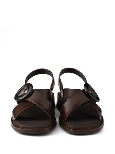 Prada Brushed Leather Crisscross Band Sandals With Plexiglas Buckle In Brown