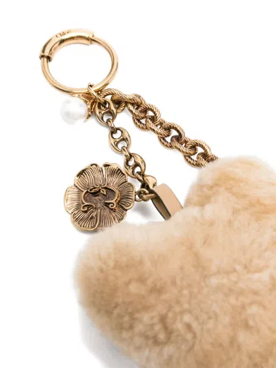 Chloé Two-tone Shearling And Metal Charm In Gold