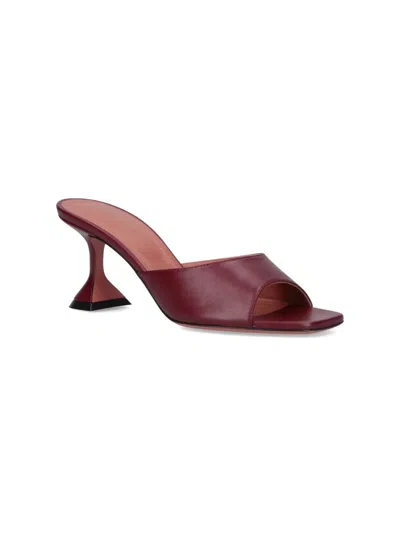 Amina Muaddi Sleek Pumps With Bold Red Heel And Contemporary Design In Brown
