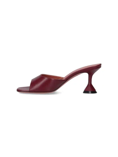 Amina Muaddi Sleek Pumps With Bold Red Heel And Contemporary Design In Brown
