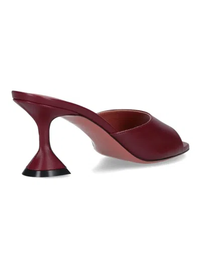 Amina Muaddi Sleek Pumps With Bold Red Heel And Contemporary Design In Brown