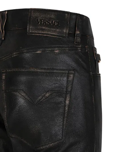Versace Button-fastening Trousers In Black
