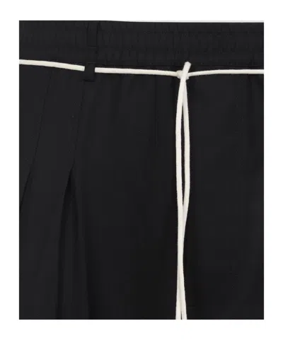 Mordecai Tapered Black Trousers With Pleated Front In Black