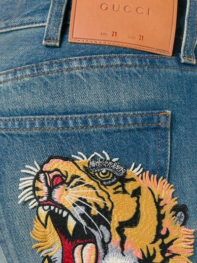 Shop Gucci Cropped Jeans With Tiger Patch - Blue