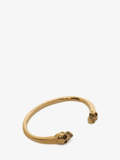 Shop Alexander Mcqueen Twin Skull Bracelet In Wood & Gold