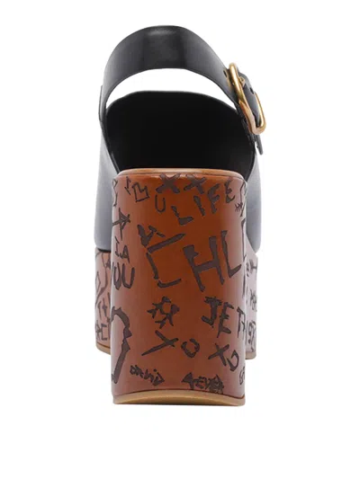 Chloé Maxime Black Wedge With Engraved Written Decorations And Logo Buckle In Leather Woman In Black