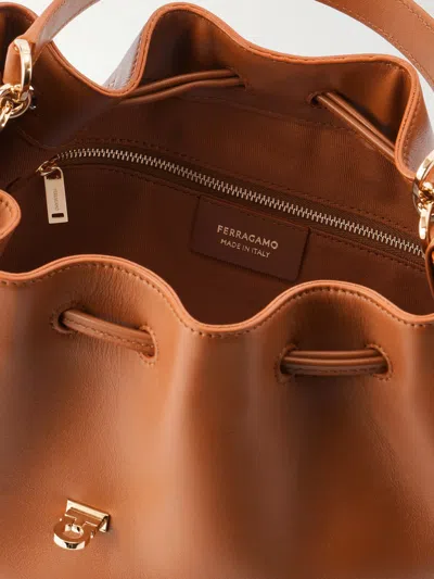 Ferragamo Hug Buckle Leather Bucket Bag In Brown