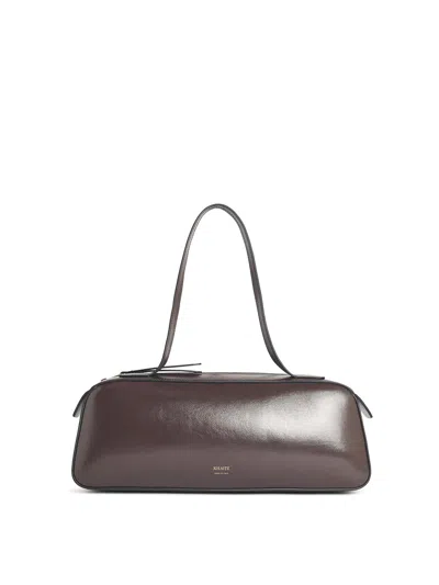 Khaite Simona Crackle Patent Elongated Tote Bag In Brown