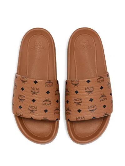 Mcm Male Monogram Print Rubber Slides In Brown