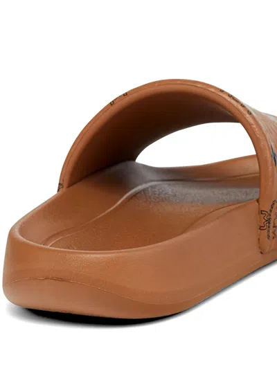 Mcm Male Monogram Print Rubber Slides In Brown