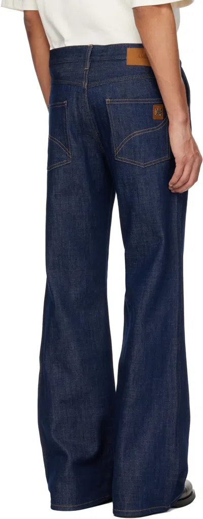 Amiri Raw Boot Cut Jeans In Blue