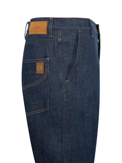 Amiri Raw Boot Cut Jeans In Blue