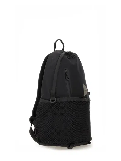 And Wander Logo Printed Backpack In Black