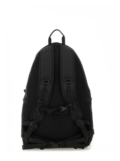 And Wander Logo Printed Backpack In Black