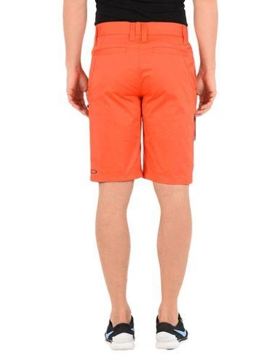 Shop Oakley Shorts & Bermuda In Orange