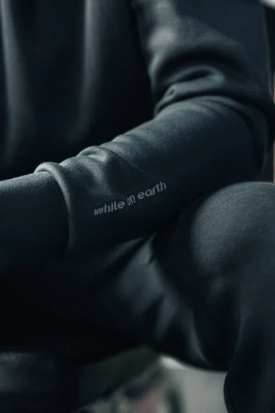 While On Earth™ Basis Hoodie In Black