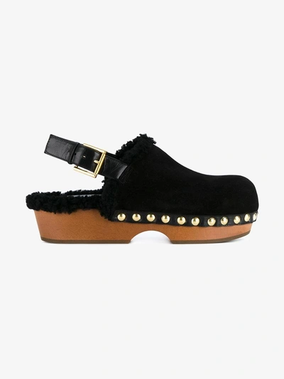 Shop Alexander Mcqueen Shearling Clogs In Black