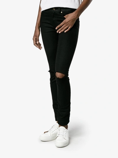 Shop Saint Laurent Distressed Skinny Jeans In Black