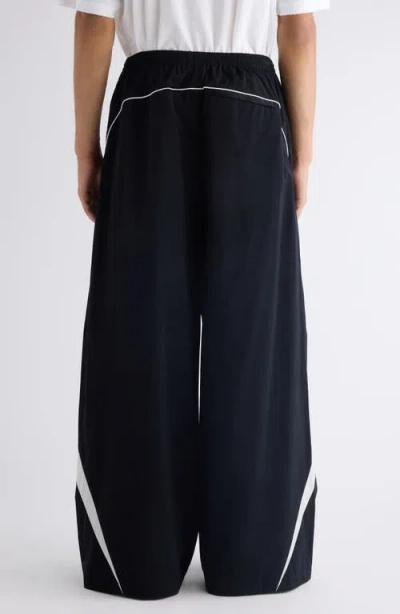 Acne Studios Color-blocked Piping Casual Pants In Black