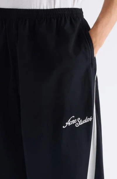 Acne Studios Color-blocked Piping Casual Pants In Black