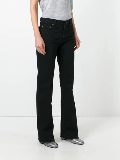 Shop Saint Laurent Flared Raw Edge Jeans In Black